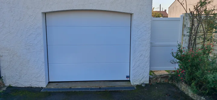Porte de garage blanche sous linteau cintré — vue 1